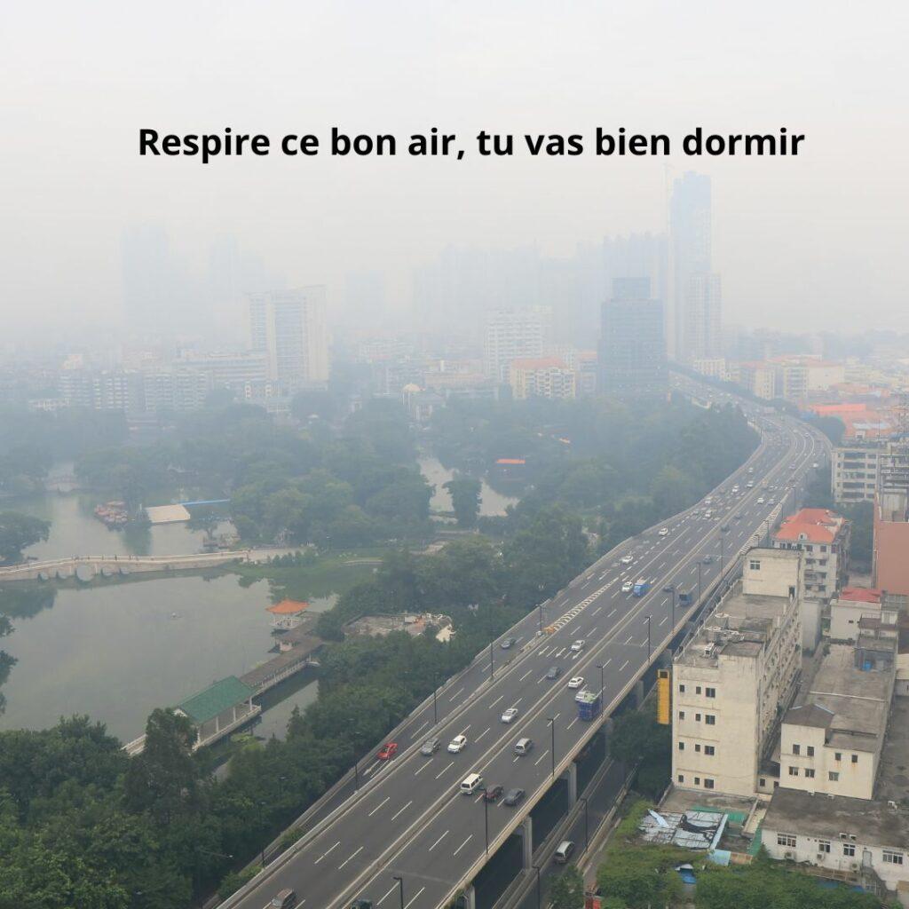 Photo d’une ville très polluée avec une autoroute au premier plan, illustrant l’irréalisme des conseils bien-être qui demandent d’aller dans la nature quand on vit en zone urbaine dense.